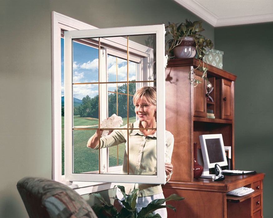 woman cleaning newly installed window in her living room